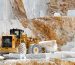 Heavy machinery extracting white Thassos marble blocks from a historic quarry, showcasing the centuries-old tradition of Thassos marble production in Greece.
