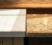 Kitchen countertop comparison showing difference between granite and quartzite - white quartzite surface on left versus speckled granite countertop on right in modern kitchen
