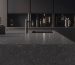 Sleek dark quartz kitchen countertop with speckled finish on large island in contemporary black kitchen design, showcasing what kitchen countertop is best for modern minimalist style with integrated sink