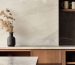 Minimalist natural stone for walls in kitchen featuring light travertine backsplash with subtle veining, warm wood cabinetry, and contemporary design elements